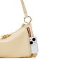 A close-up of a light beige leather shoulder bag with gold-tone hardware, featuring a side zipper pocket containing a white smartphone, set against a plain white background.