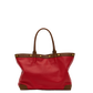 A red leather tote bag with brown leather trim, double top handles, and gold-tone metal studs, shown against a plain white background.