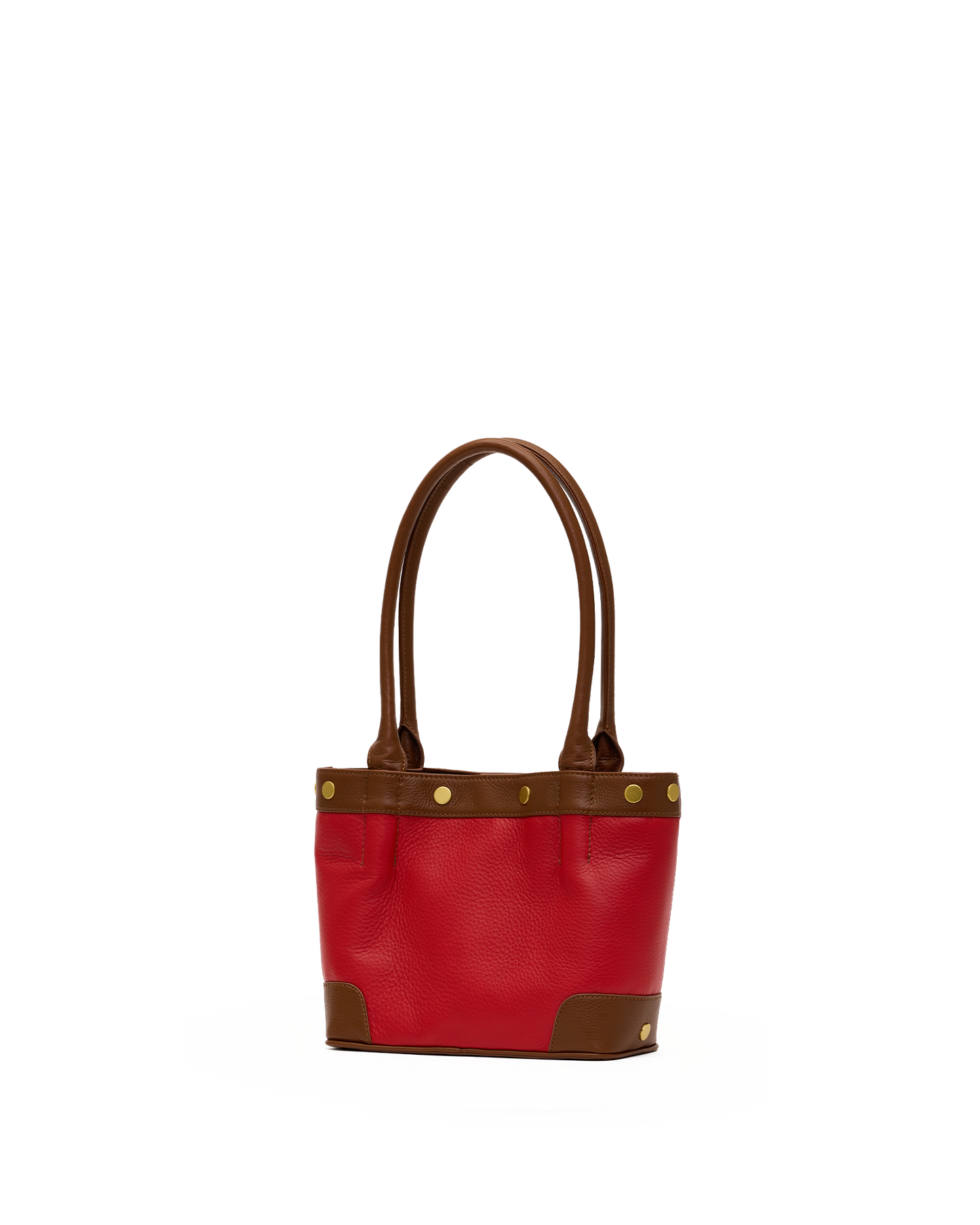 A red leather tote bag with brown leather handles, trim, and corner protectors, accented by gold-tone metal studs, shown against a plain white background.