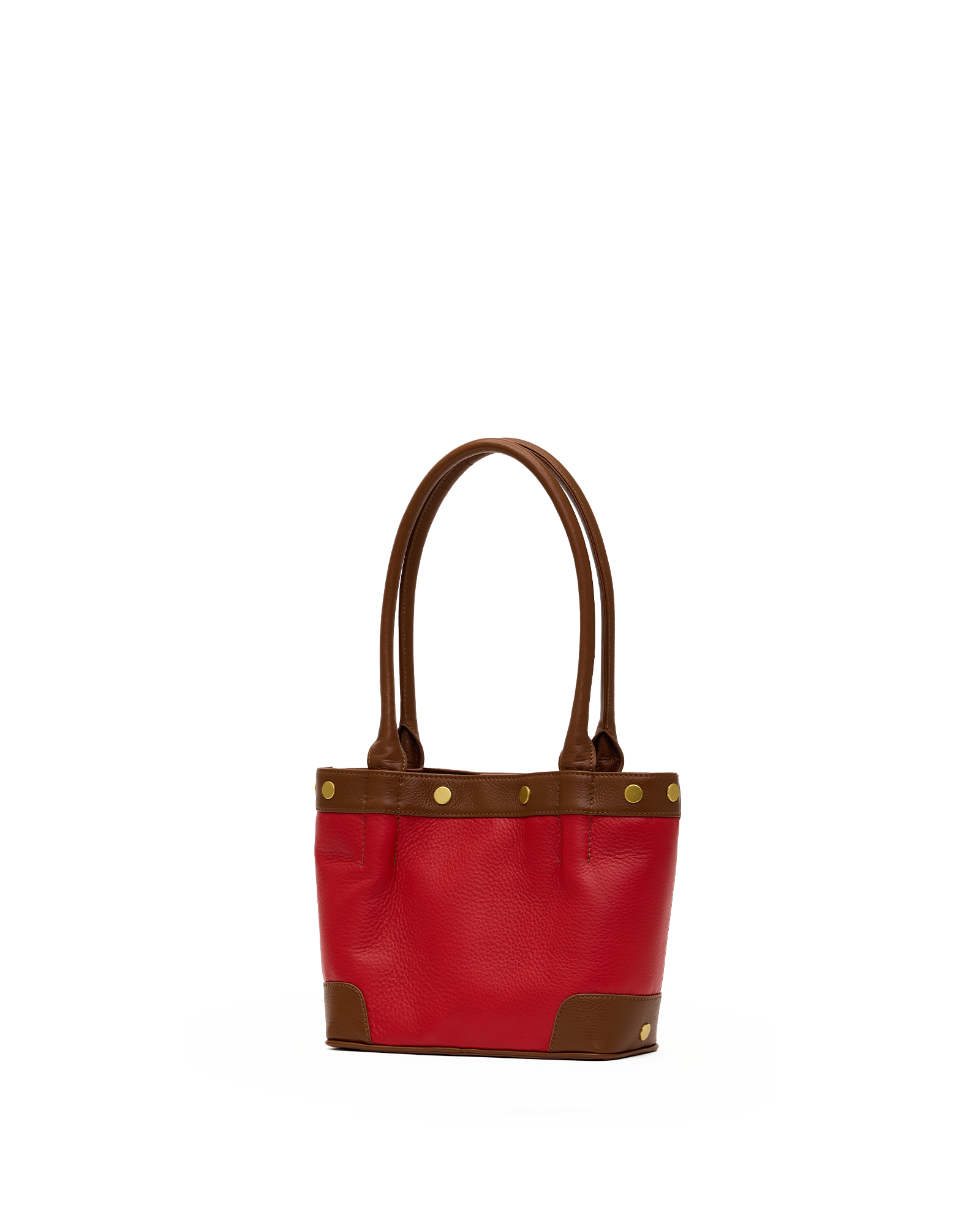 A red leather tote bag with brown leather handles, trim, and corner protectors, accented by gold-tone metal studs, shown against a plain white background.