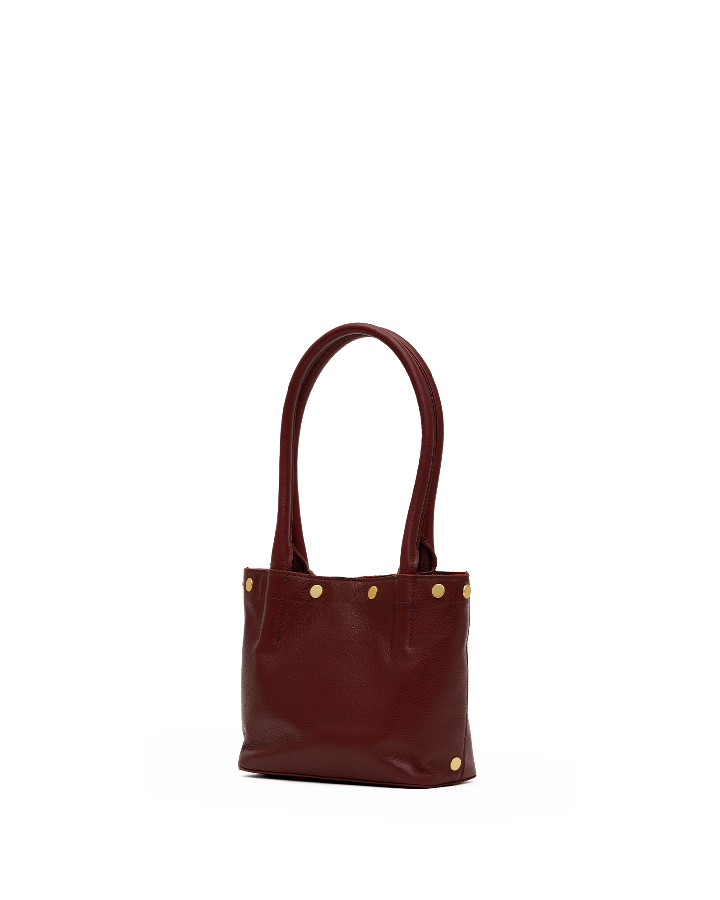 A small leather tote bag in deep burgundy with gold-tone metal studs and double top handles, shown against a plain white background.