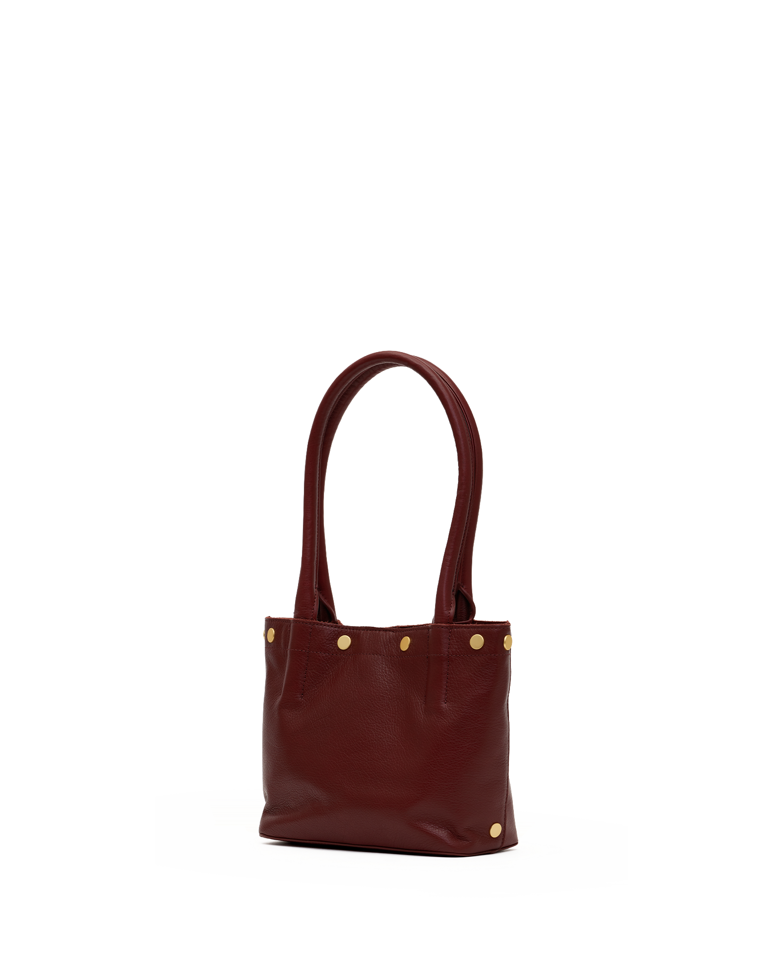 A small leather tote bag in deep burgundy with gold-tone metal studs and double top handles, shown against a plain white background.