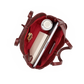 An overhead view of a dark red leather tote bag shown open, filled with a laptop, notebook, pen, and a white travel mug, on a solid white background.