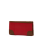 A red pebbled leather wallet with brown leather corner and trim accents, shown from a side profile view on a plain white background.