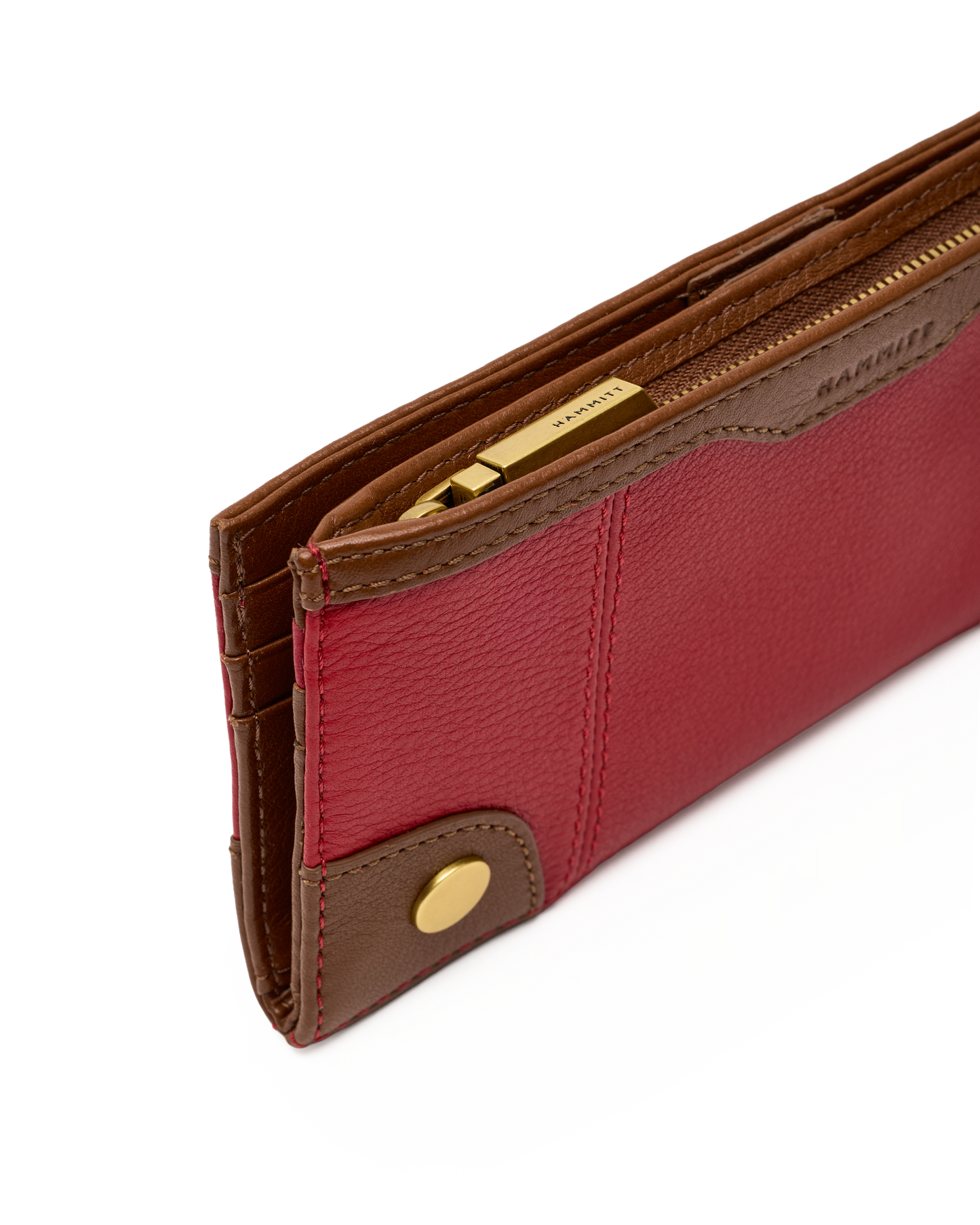 A close-up of a Barrie leather wallet in red and brown with gold-tone hardware, showing the interior card slots and zipper.