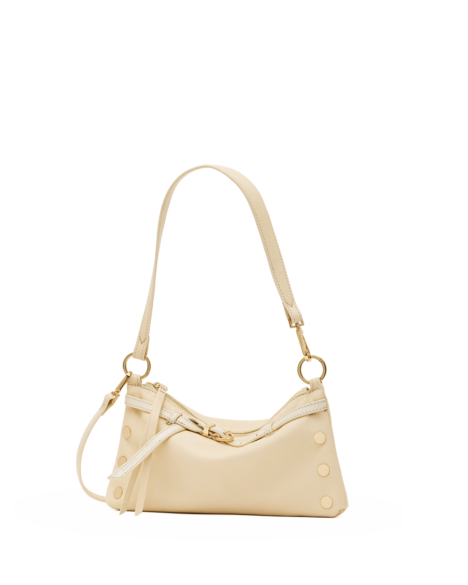 A cream-colored leather shoulder bag with gold-tone hardware, featuring a curved top, decorative rivet studs, and a long shoulder strap, shown against a plain white background.
