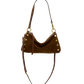A brown suede crescent-shaped shoulder bag with gold-tone hardware and a long adjustable strap.