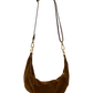 A brown suede crescent-shaped shoulder bag with a matching brown leather strap and gold-tone hardware, shown against a plain white background.
