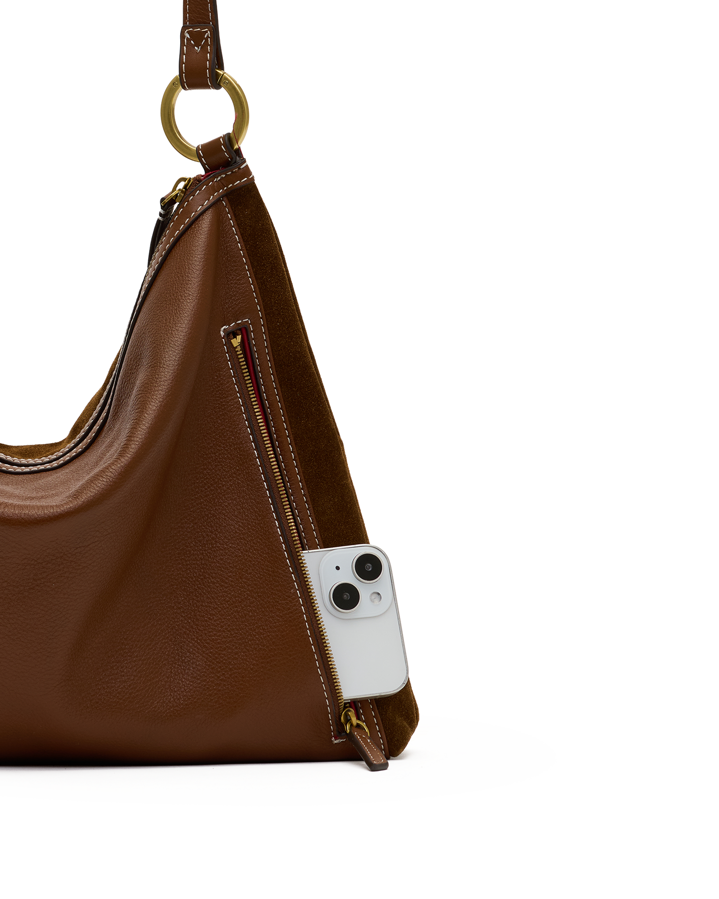 A brown leather shoulder bag with a gold-tone ring detail and a side zip pocket, shown with a white smartphone inserted into the pocket against a white background.