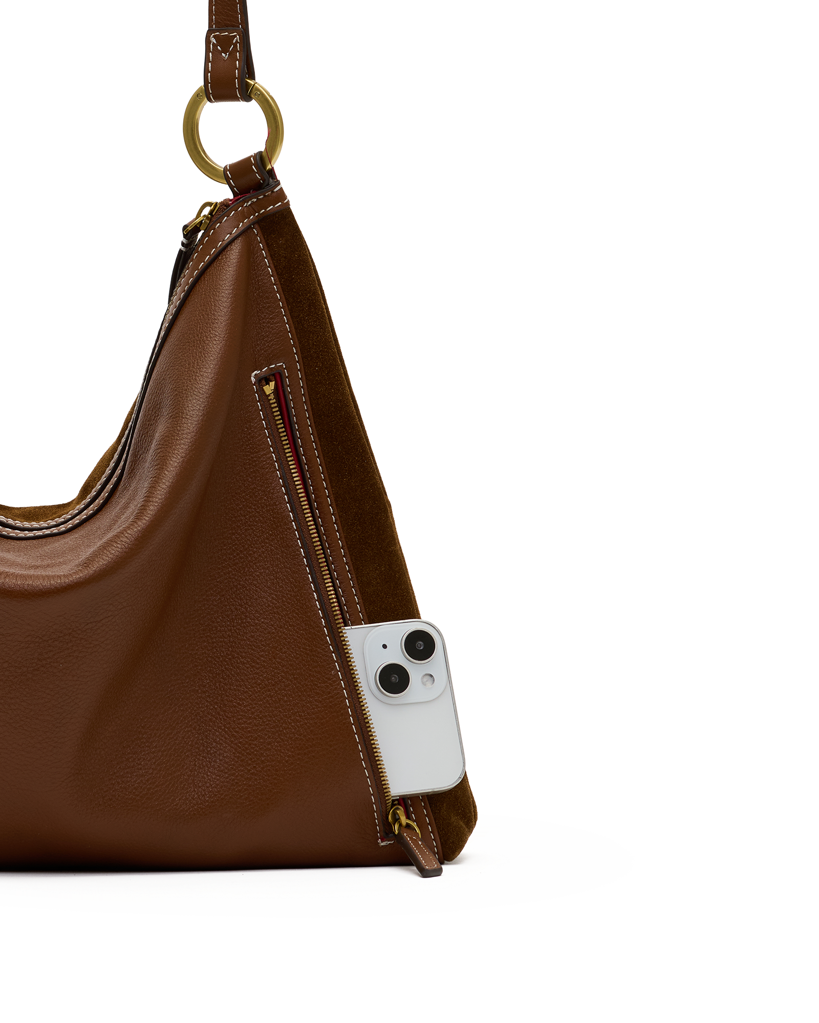 A brown leather shoulder bag with a gold-tone ring detail and a side zip pocket, shown with a white smartphone inserted into the pocket against a white background.