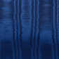 A close-up of a textured royal blue fabric with a fine ribbed or pleated pattern.