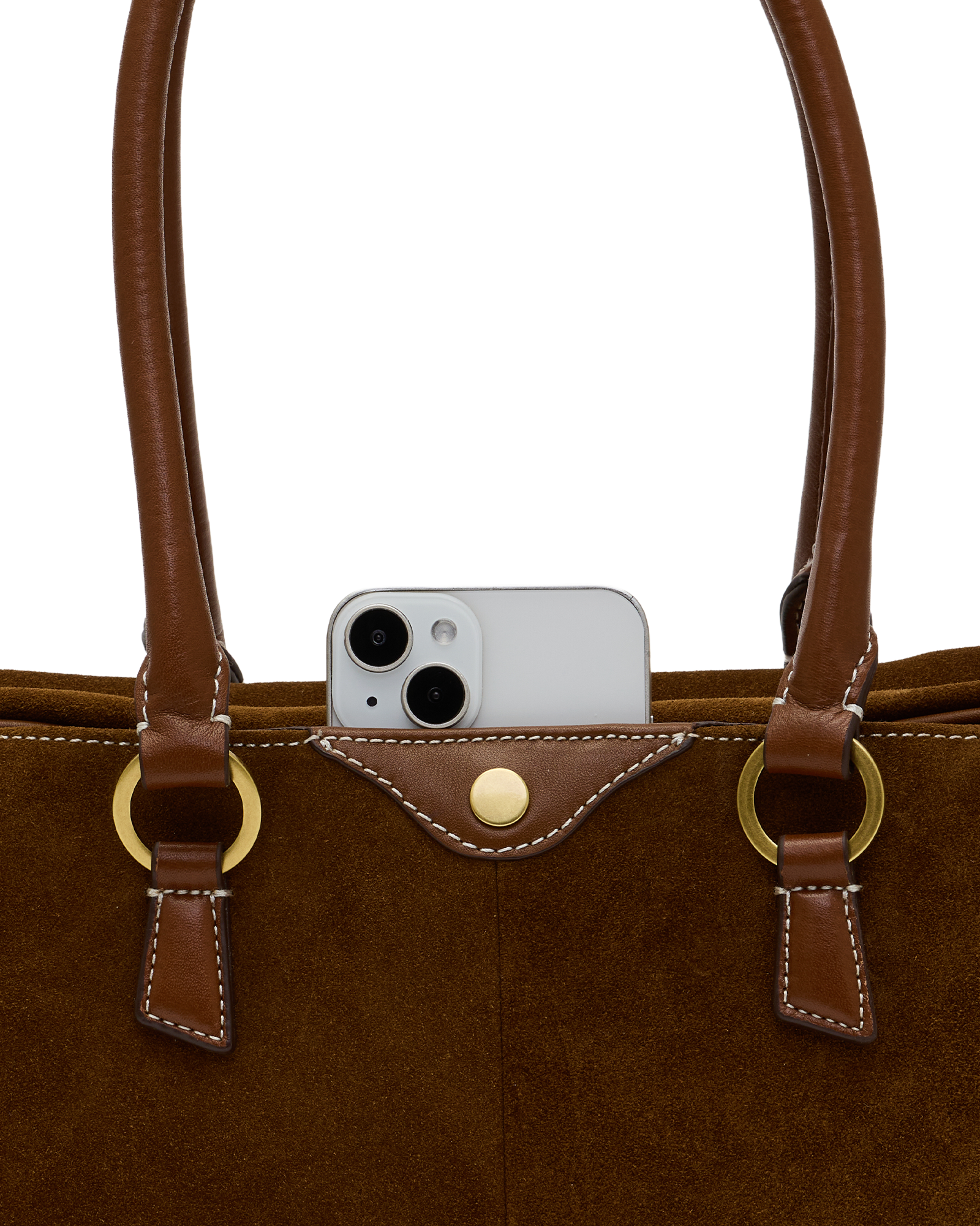 Close-up of a brown suede and leather tote bag with gold-tone hardware, shown against a white background with a silver smartphone partially tucked into the front pocket.