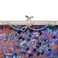A close-up of a purple sequined clutch purse with orange, green, and pink sequins, featuring a silver metal frame and bow clasp against a white background.