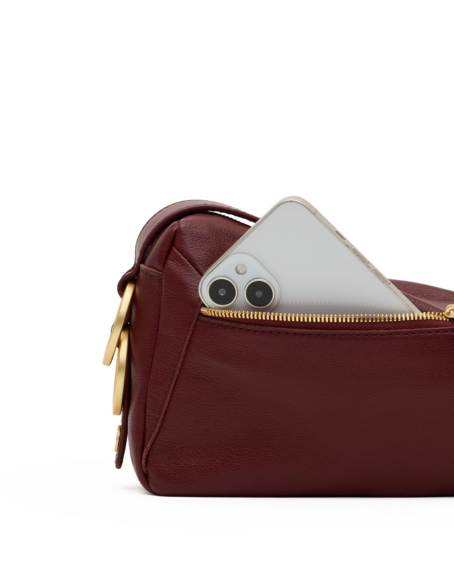 A close-up of a burgundy leather pouch with a gold zipper, showing a silver smartphone partially inserted into the pocket, on a white background.