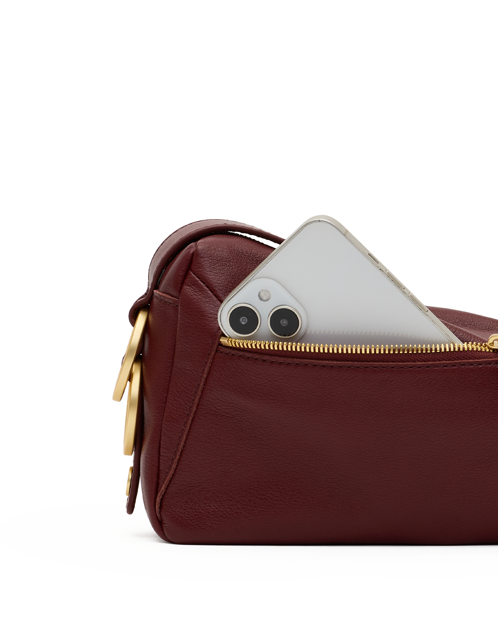 A close-up of a burgundy leather pouch with a gold zipper, showing a silver smartphone partially inserted into the pocket, on a white background.