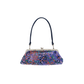A small handbag with a dark navy blue strap and a purple base covered in a multicolor floral pattern, featuring a silver-tone kiss-lock frame closure.