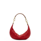 A red leather crescent-shaped shoulder bag with gold-tone hardware and a brown strap, shown against a plain white background.