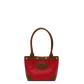 A red leather handbag with brown leather trim, double top handles, and a circular embossed logo patch on the front, set against a plain white background.