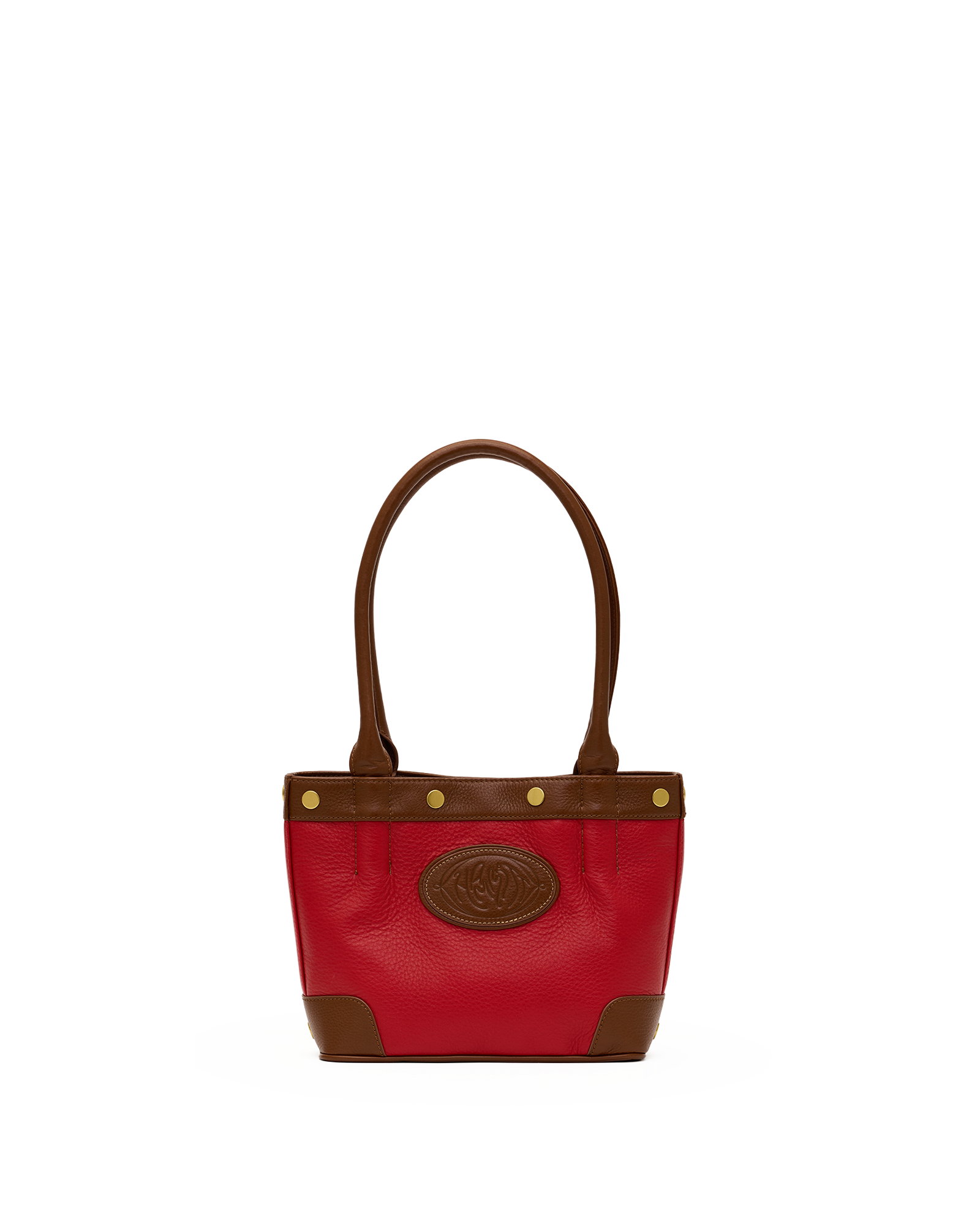 A red leather handbag with brown leather trim, double top handles, and a circular embossed logo patch on the front, set against a plain white background.