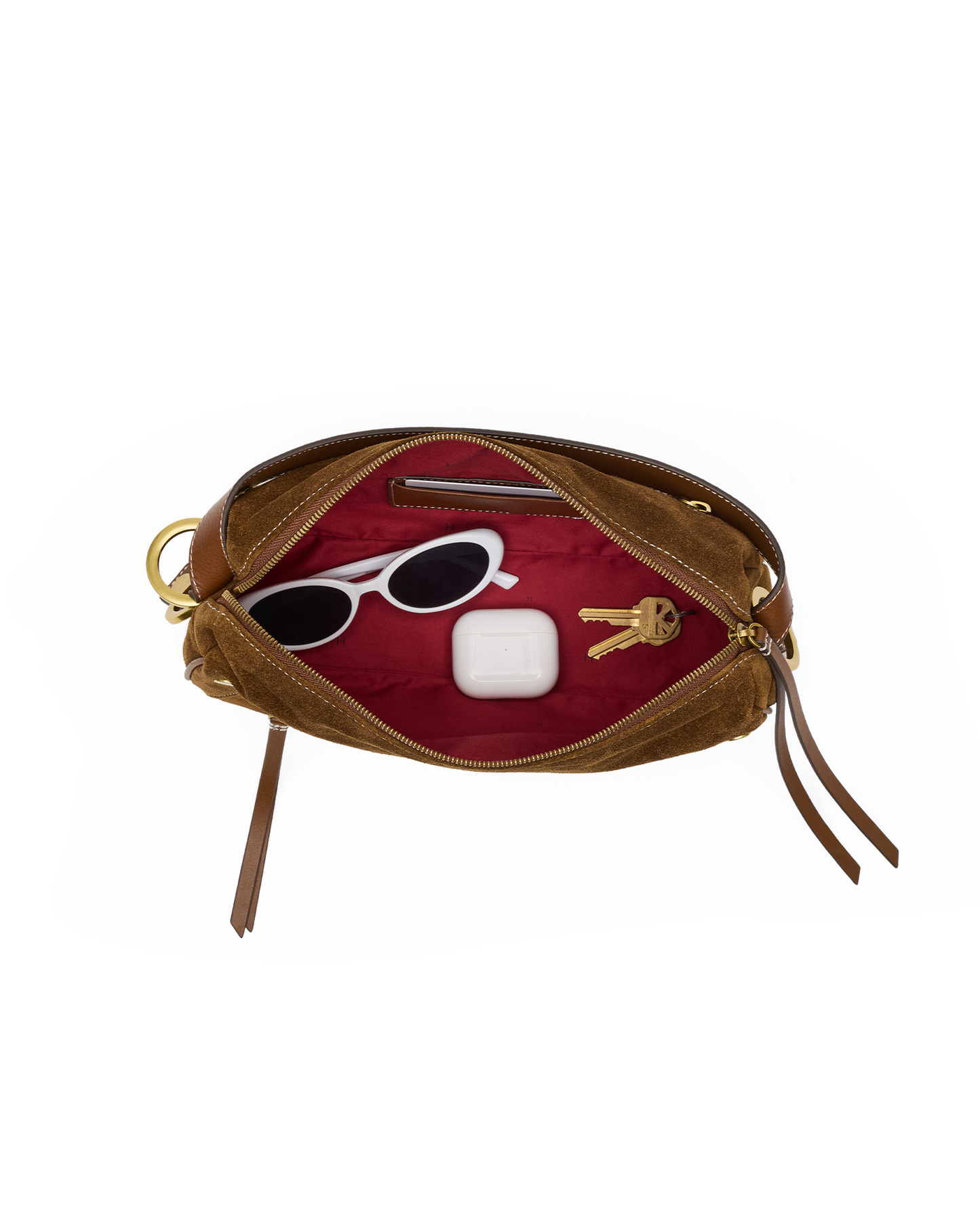 An open brown leather pouch with a deep red velvet interior, shown against a plain white background. Inside, a pair of white sunglasses and a white rectangular item are arranged.