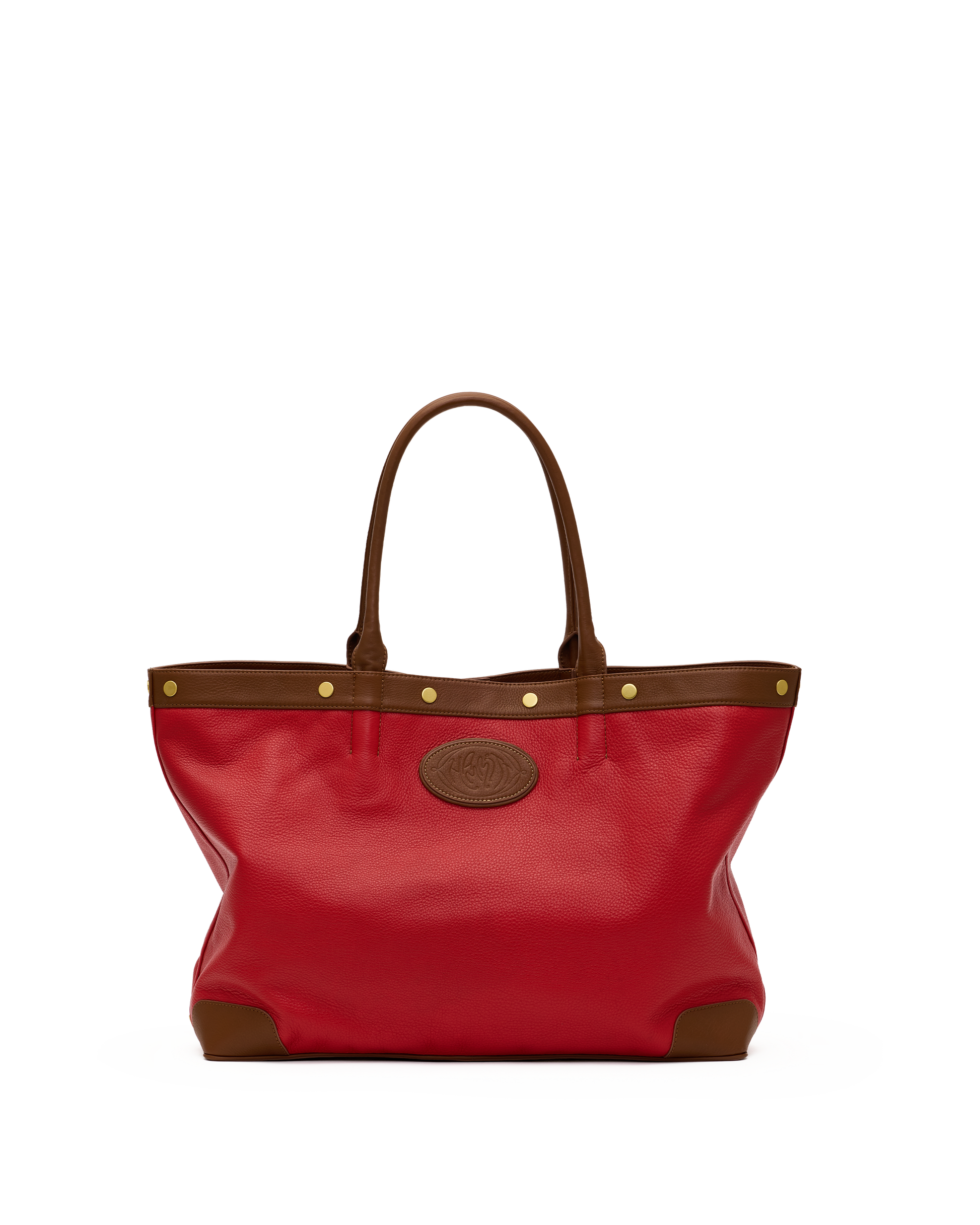 A red leather tote bag with brown leather trim, double top handles, gold-tone hardware, and a circular embossed logo patch on the front, shown against a plain white background.