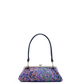 A small structured handbag with a dark navy blue handle, a silver-tone kiss-lock frame, and a vibrant multicolor floral patterned body, shown against a plain white background.