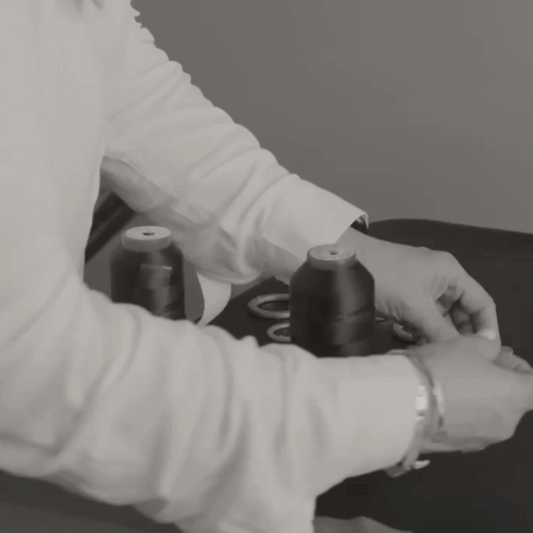 Animated gif of someone making a Hammitt handbag and putting in our signature rivets.