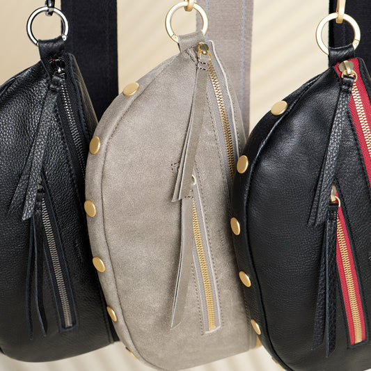 Three Charles med hanging fron their straps. Colors shown are black gunmetal, pewter brushed gold, & black brushed gold red zip.